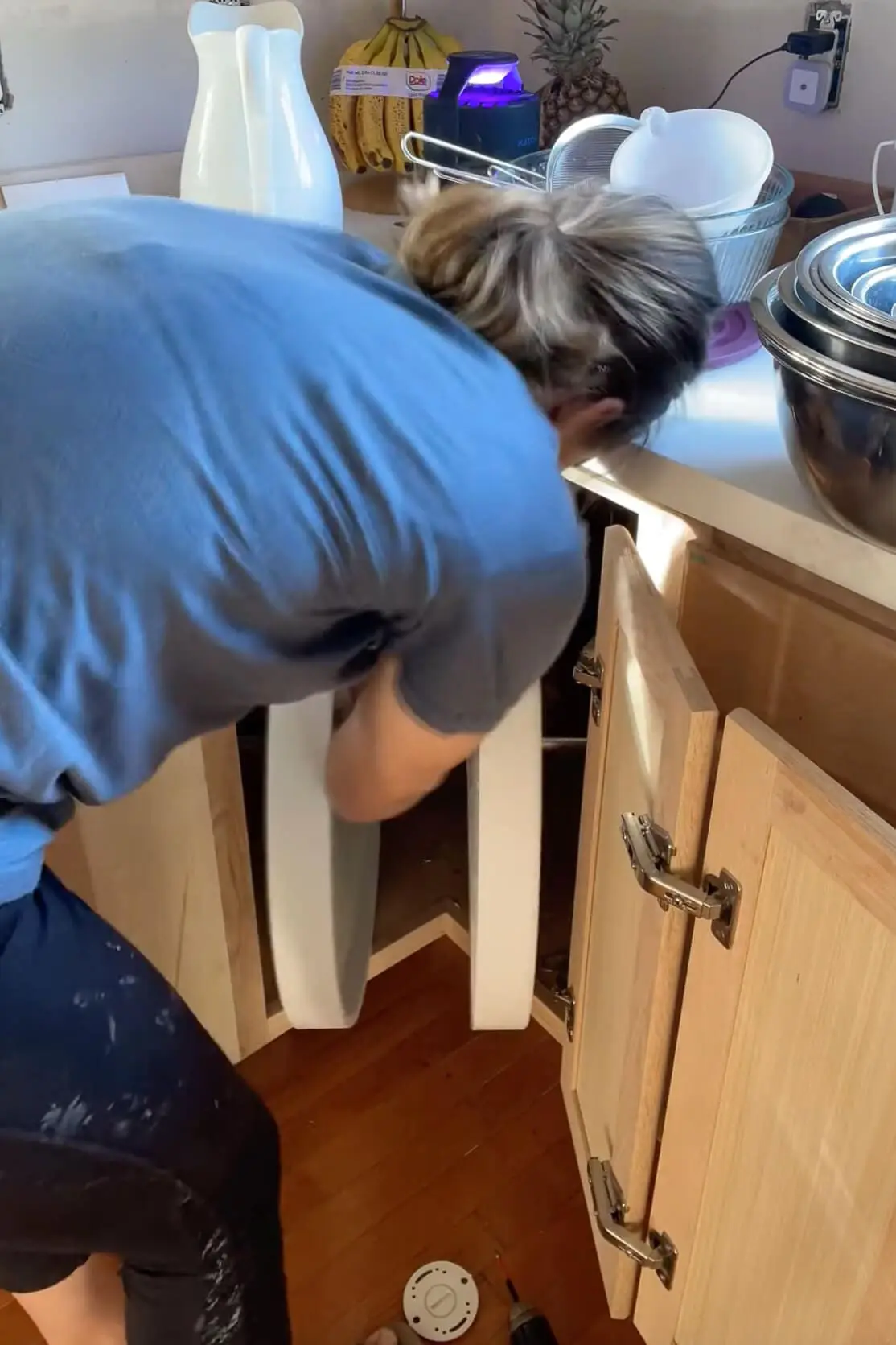 Removing a Lazy Susan from a kitchen cabinet.